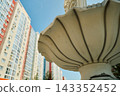 Decorative Park Bench and Tiered Fountain on Paved City Plaza 143352452