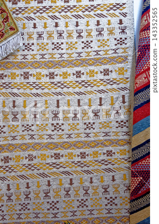 Traditional Tunisian Handcrafted Textiles and Ornate Ceramic Pillar Detail Traditional Tunisian Handcrafted Textiles and Ornate Ceramic Pillar Detail 143352565