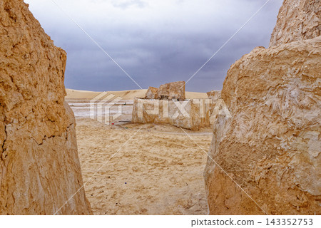 Desert Sand Dunes and Mud Structures Framed by Textured Plaster Walls Desert Sand Dunes and Mud Structures Framed by Textured Plaster Walls 143352753