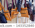 Hanging Display of Handcrafted Leather Messenger Bags and Shoulder Pouches with Zippers 143352840