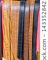 Close Up Full Frame Texture Shot of Assorted Embossed and Patterned Genuine Leather Belts 143352842