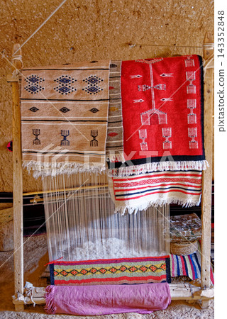 Traditional Berber Wooden Weaving Loom with Handwoven Patterned Rugs and Textiles Traditional Berber Wooden Weaving Loom with Handwoven Patterned Rugs and Textiles 143352848