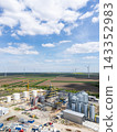 Construction of a modern agricultural grain terminal with wind turbines on the horizon 143352983