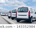 White delivery vans are parked in rows. Commercial fleet of vehicles 143352984