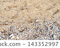 Close-up of sea sand and colorful pebbles on a beach. 143352997