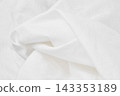 Close up of smooth white cotton fabric with soft flowing folds and waves, minimalist background 143353189