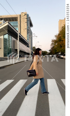 Businesswoman Crossing City Street at a Pedestrian Crossing Businesswoman Crossing City Street at a Pedestrian Crossing 143353354