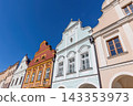 Telc Zacharias Square. Side view of the three colorful Baroque houses. Blue sky in the background. Czech republic. 143353973