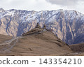 Gergeti Trinity Church in Kazbegi Georgia Against Snow Covered Caucasus Mountain 143354210