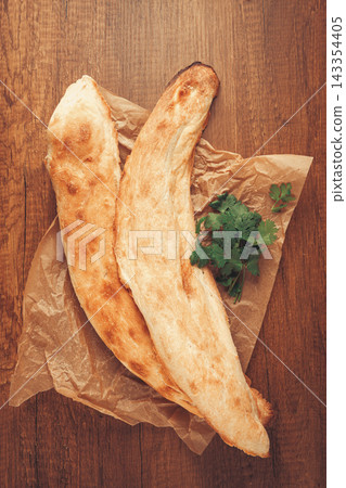 Georgian bread shotis, shotis puri, on a wooden table, top view, 143354405