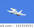 CF-18 Hornet Air Force fighter aircraft flying on a blue sky background 143354591