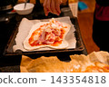 Adding cheese and toppings to homemade pizza before baking 143354818