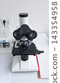 Professional laboratory microscope on a table indoors 143354958