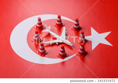 A mock up of airplane surrounded by no fly signs on a Turkish flag A mock up of airplane surrounded by no fly signs on a Turkish flag 143355472
