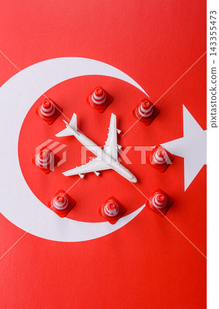 A mock up of airplane surrounded by no fly signs on a Turkish flag A mock up of airplane surrounded by no fly signs on a Turkish flag 143355473