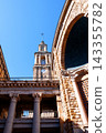 Architectural view of Laboral Ciudad de la Cultura in Gijon (Asturias), Spain. Monumental historic complex featuring a stone facade, massive arch and classical columns with Corinthian capitals  143355782