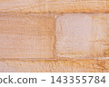 Detailed surface of a natural beige sandstone wall with rustic masonry joints and rough mineral texture. Architectural stone background  143355784