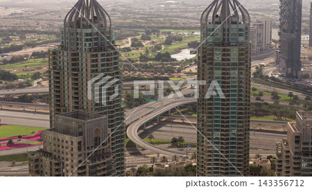 Dubai Marina skyscrapers and jumeirah lake towers sunrise view from the top aerial timelapse in the United Arab Emirates. Dubai Marina skyscrapers and jumeirah lake towers sunrise view from the top aerial timelapse in the United Arab Emirates. 143356712