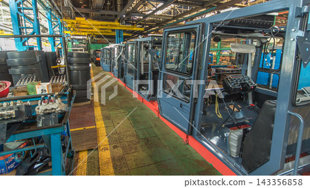 Conveyor assembly stage the body of tractor at big industrial factory timelapse 143356858