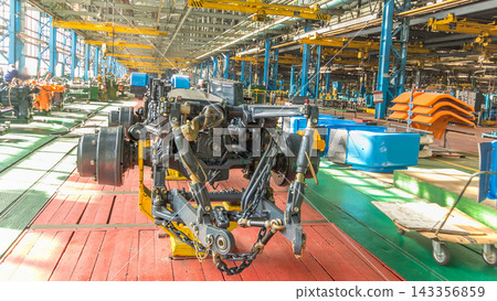 Conveyor assembly stage the body of tractor at big industrial factory timelapse Conveyor assembly stage the body of tractor at big industrial factory timelapse 143356859