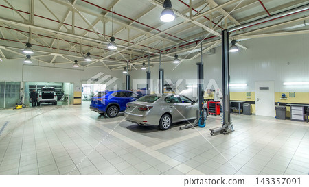Cars moves on lifts in modern service station and men repair cars timelapse hyperlapse. 143357091