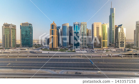 Aerial view of Jumeirah lakes towers skyscrapers all day timelapse with traffic on sheikh zayed road. Aerial view of Jumeirah lakes towers skyscrapers all day timelapse with traffic on sheikh zayed road. 143357158