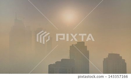 Foggy morning sunrise in downtown of Dubai timelapse. 143357166