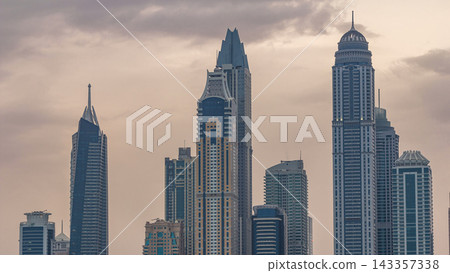 Modern skyscrapers in Dubai city night to day timelapse from the Palm Jumeirah Island. Modern skyscrapers in Dubai city night to day timelapse from the Palm Jumeirah Island. 143357338
