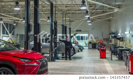 Cars moves on lifts in modern service station and men repair cars timelapse. Cars moves on lifts in modern service station and men repair cars timelapse. 143357457