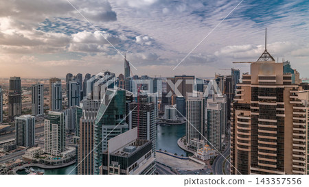 Dubai Marina skyscrapers and jumeirah lake towers view from the top aerial timelapse in the United Arab Emirates. Dubai Marina skyscrapers and jumeirah lake towers view from the top aerial timelapse in the United Arab Emirates. 143357556