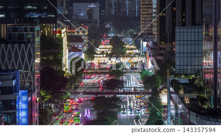 Traffic with cars on a street and urban scene in the central district of Singapore day to night timelapse Traffic with cars on a street and urban scene in the central district of Singapore day to night timelapse 143357594