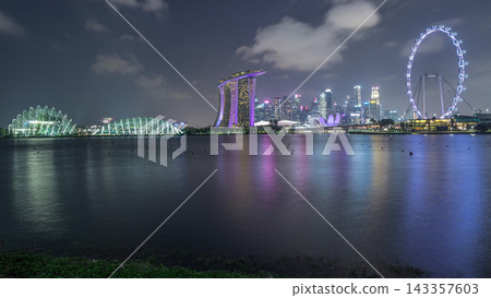 Downtown skyline of Singapore as viewed from across the water from The Garden East day to night timelapse. Singapore. Downtown skyline of Singapore as viewed from across the water from The Garden East day to night timelapse. Singapore. 143357603