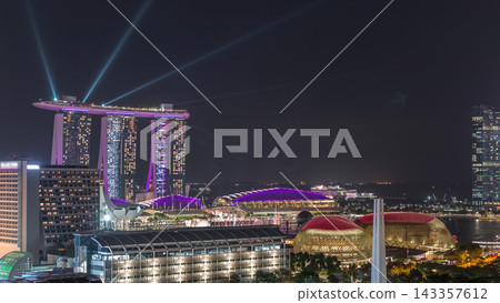 Fifty-five storeys high Marina Bay Sands Hotel dominates the skyline at Marina Bay in Singapore aerial night timelapse. Fifty-five storeys high Marina Bay Sands Hotel dominates the skyline at Marina Bay in Singapore aerial night timelapse. 143357612