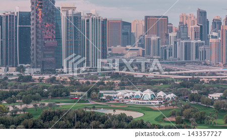 Jumeirah lake towers and Dubai marina skyscrapers and golf course night to day timelapse, Dubai, United Arab Emirates Jumeirah lake towers and Dubai marina skyscrapers and golf course night to day timelapse, Dubai, United Arab Emirates 143357727
