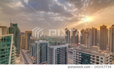 Sunrise view of various skyscrapers and towers in Dubai Marina from above aerial timelapse Sunrise view of various skyscrapers and towers in Dubai Marina from above aerial timelapse 143357734
