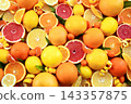 Colorful bright background of fresh ripe sweet citrus fruits: orange and tangerine, yellow lemon and grapefruit 143357875