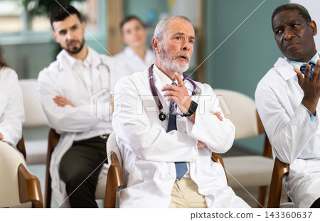 During lecture meeting, adult medical pupils listen and look to teacher During lecture meeting, adult medical pupils listen and look to teacher 143360637