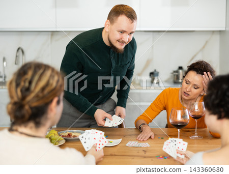 Two married couples playing card game poker Two married couples playing card game poker 143360680