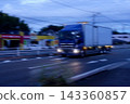 A van-type truck for work speeding down the road in the early morning 143360857