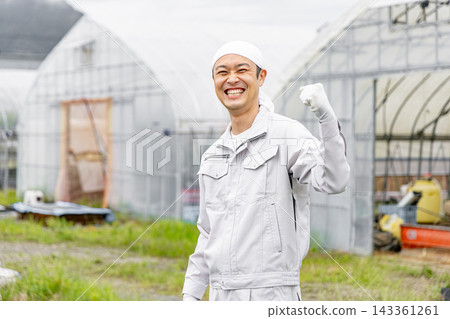 A man wearing work clothes A man wearing work clothes 143361261