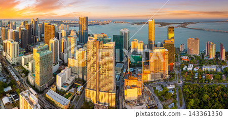 Downtown district of Miami Brickell in Florida, USA. Evening urban landscape of waterfront skyscraper buildings in modern American megapolis Downtown district of Miami Brickell in Florida, USA. Evening urban landscape of waterfront skyscraper buildings in modern American megapolis 143361350