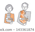 A smiling senior woman holding a cat and a senior man holding a dog. 143361874