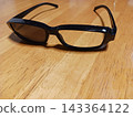 Unique sunglasses with one lens missing, creating an odd scene. 143364122