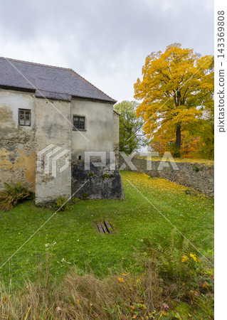 Nove Hrady castle wall and vibrant autumn tree Nove Hrady castle wall and vibrant autumn tree 143369808