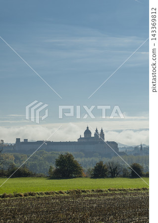 Melk Abbey appearing through morning clouds Melk Abbey appearing through morning clouds 143369812
