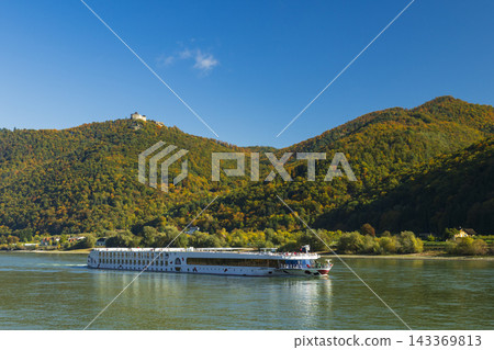 River cruise ship navigating Danube river in Wachau valley River cruise ship navigating Danube river in Wachau valley 143369813