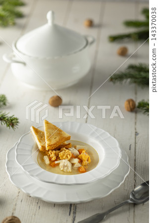 Winter chicken soup with croutons for holiday dinner Winter chicken soup with croutons for holiday dinner 143370038