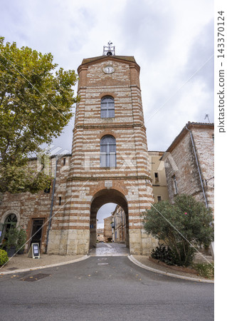 Clock tower entrance welcoming visitors in Auvillar, France 143370124