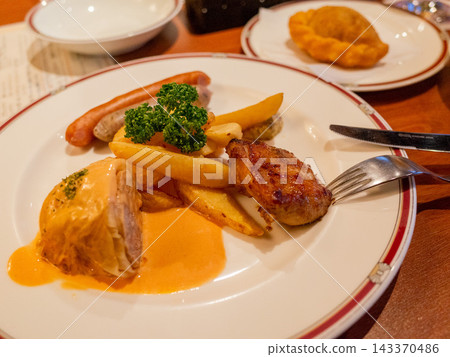 Cabbage rolls and sausages served on a plate Cabbage rolls and sausages served on a plate 143370486