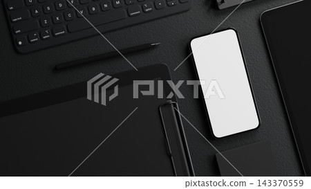 Top view of black desk surface with blank screen smartphone, keyboard, tablet stylus and clipboard. 143370559
